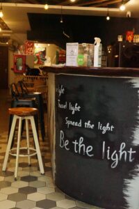 The Lighthouse front desk with the words travel light spread the light be the light